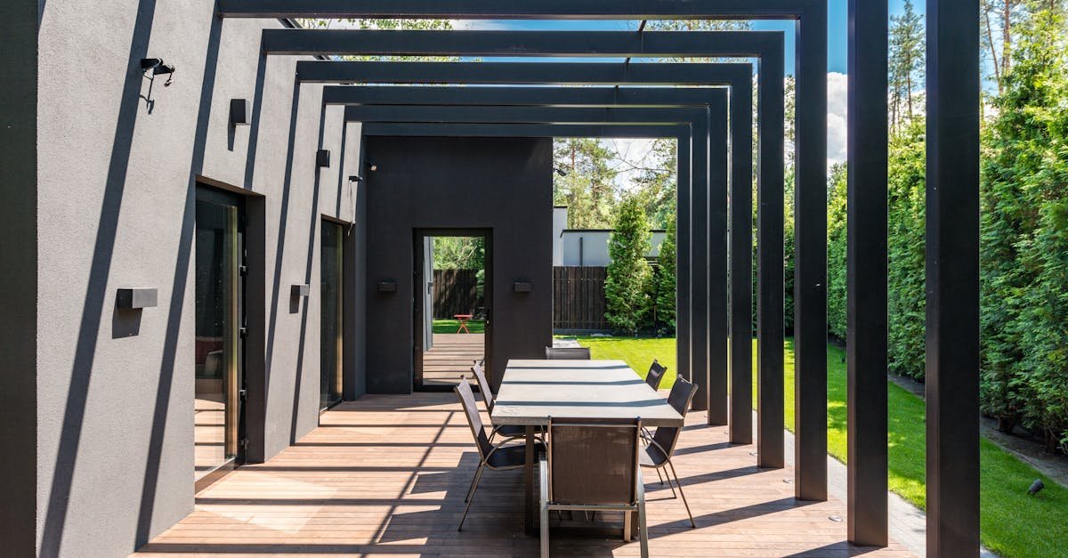 Outdoor dining set beneath a pergola on a patio