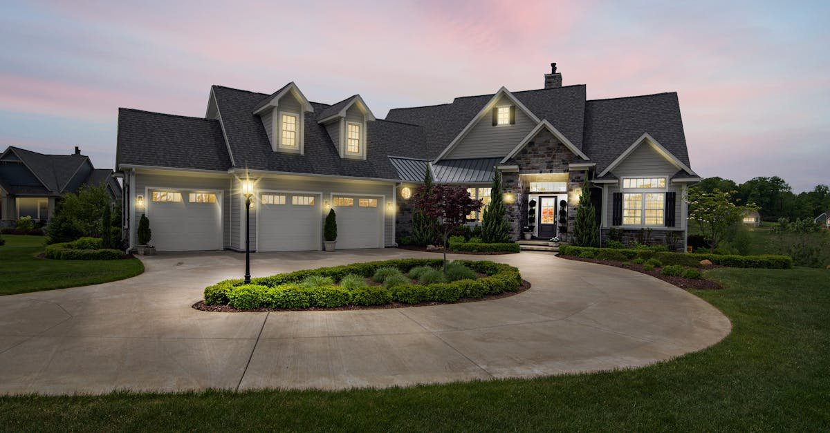 House exterior at dusk with warm porch lighting and clear walkway