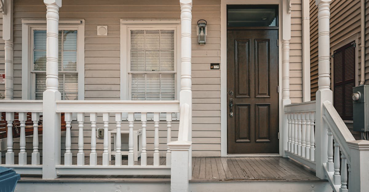 Classic front porch with decorative entry and picket fence